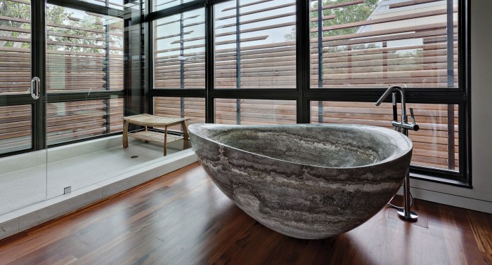 Natural stone bathtub rustic carved accents bathroom outdoor interior